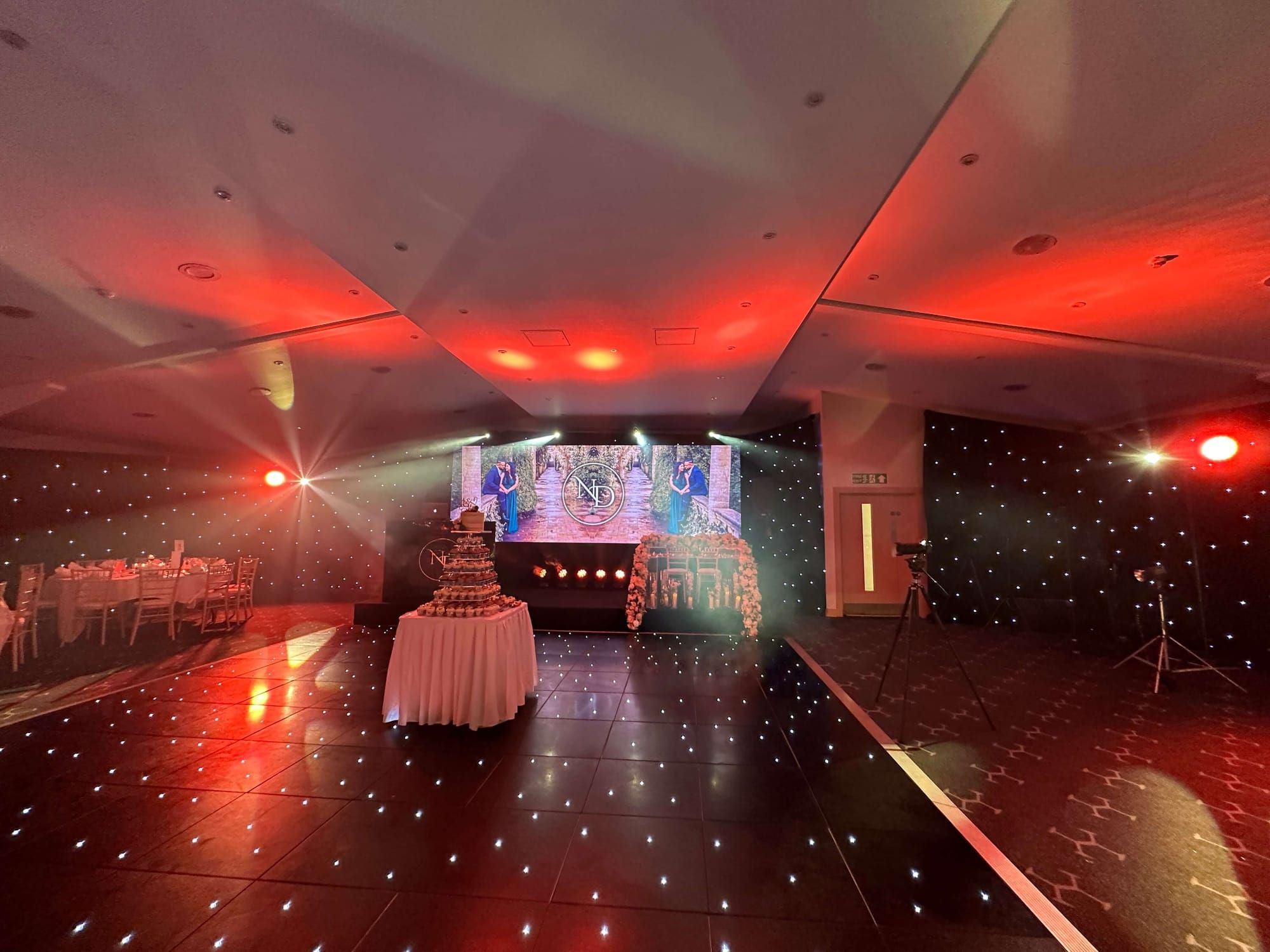 An awards evening with a starlit dancefloor in front of a red-lit LED stage