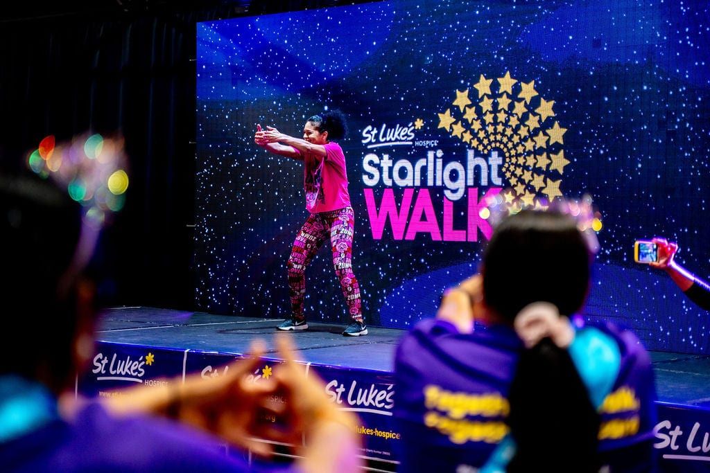 A performer on the Starlight Walk stage with children watching from the front
