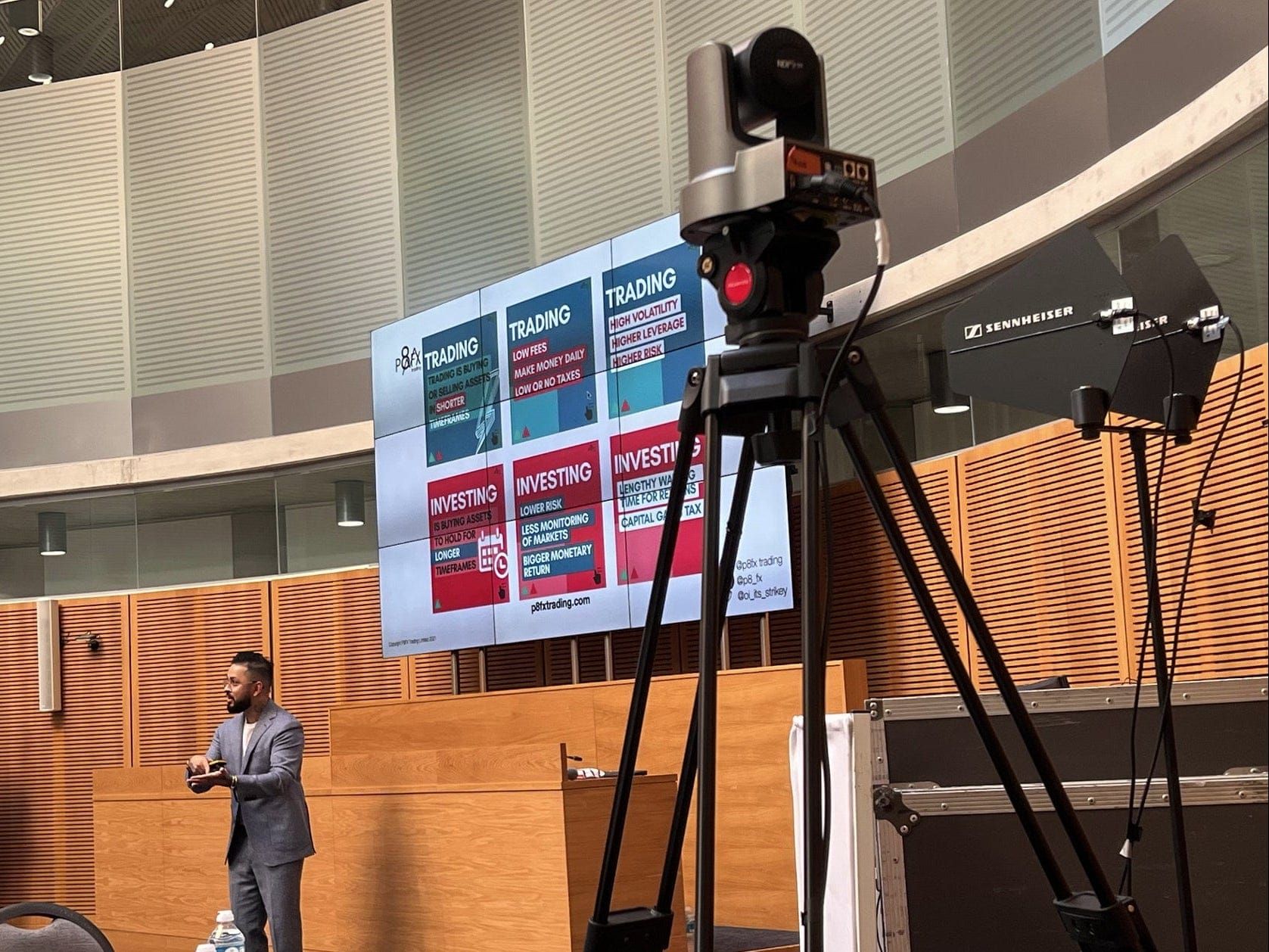 A robotic camera and presentation screens set up in a tiered lecture theatre