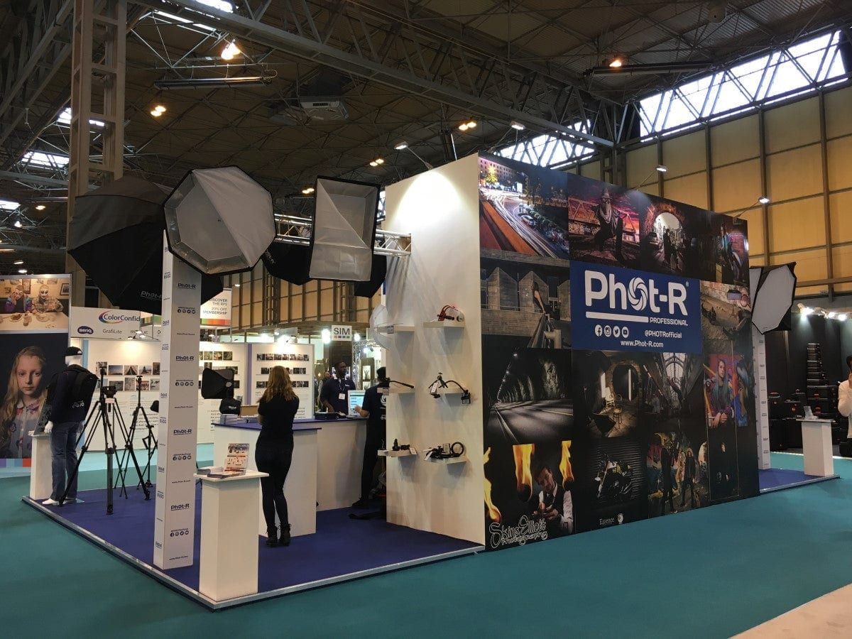 A photography exhibition stand with product displays and lighting rigs